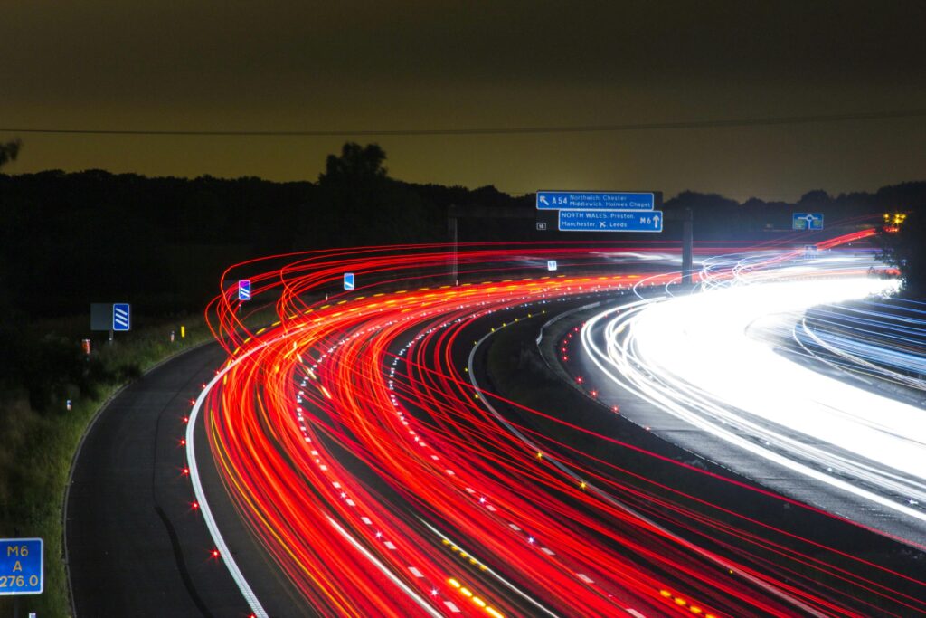 Long exposure shot of a highway at night with striking light trails.